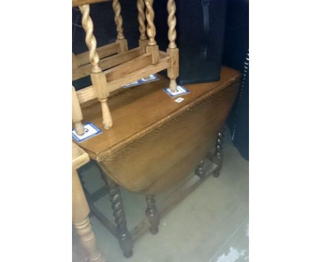 An oak barley twist gate leg table