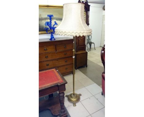 A telescopic brass standard lamp with silk shade