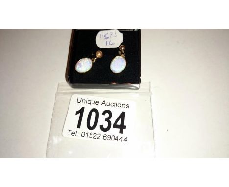 A pair of 9ct gold opal earrings