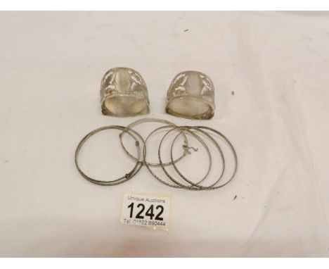4 silver bangles, 2 silver bracelets and a pair of celtic silver napkin rings