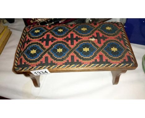 A tapestry covered folding prayer chair