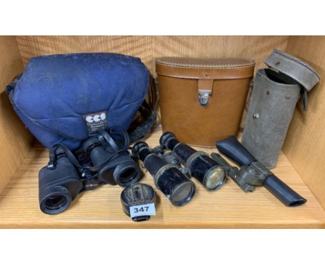 A military marching compass dated 1942 together with three pairs of binoculars and a military scope.