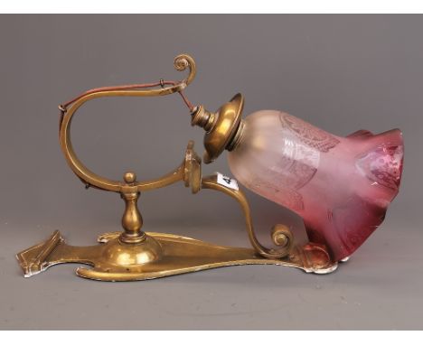 A lovely Art Nouveau brass hanging electric wall lamp and frosted cranberry shade, H. 33cm.
