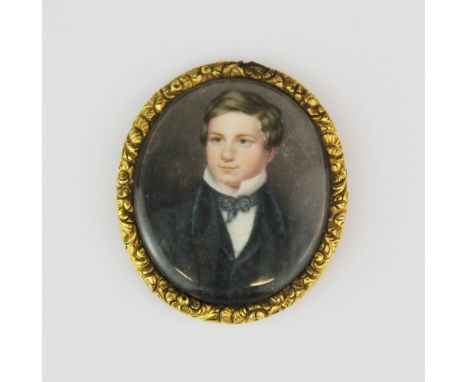 A 18th/ early 19th century hand painted portrait miniature of a young man, L. 5cm.