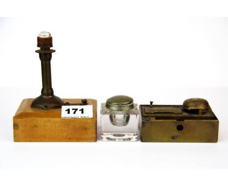 A small early battery operated light house lamp with two inkwells.