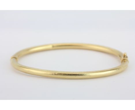 A 14ct yellow gold (stamped 14k) bangle, Dia. 7cm, approx. 7.2gr.&nbsp;