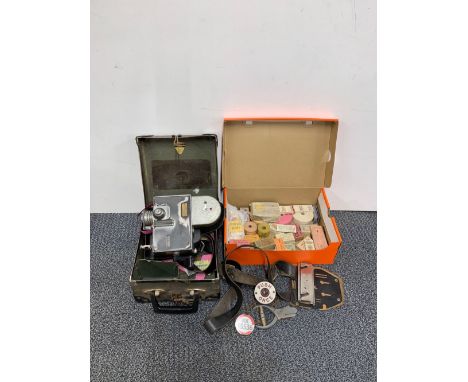 A vintage bus conductors case, ticket machine and additional paraphernalia.
