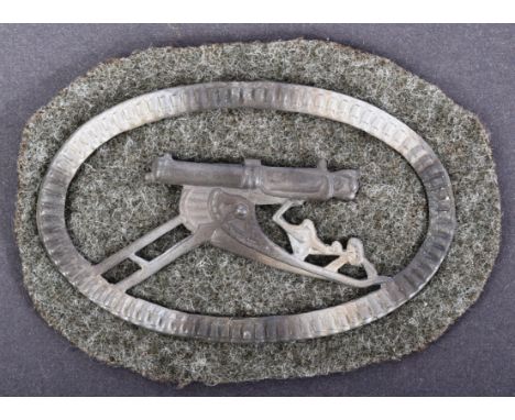 A WWI First World War Imperial German Army Machine Gunners uniform sleeve patch badge. White metal side profile of a machine 