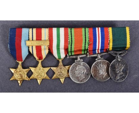 A WWII Second World War miniature medal group suspended on original ribbons and mounted onto a bar. Medals comprising; Defenc