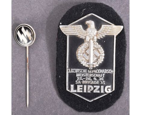 A WWII Second World War Third Reich Nazi German SA / SS Leipzig marching championship breast badge along with an enamel SS st