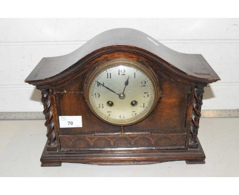 An oak cased mantel clock with barley twist supports