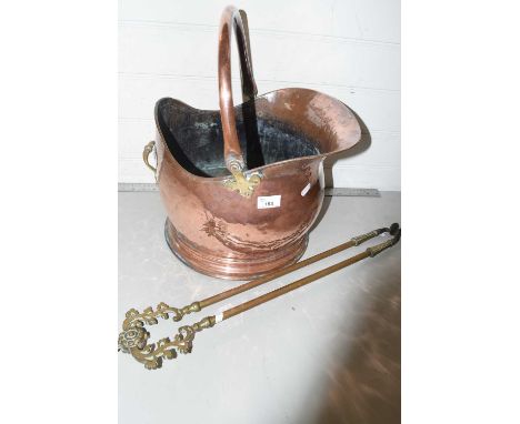 Copper coal helmet and a pair of brass fire tongs