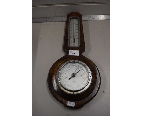 An oak cased barometer and thermometer