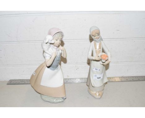 A Nao figure of a girl with a lamb and one other