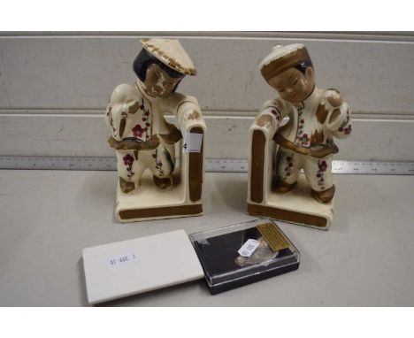 A pair of Oriental style ceramic book ends together with a section of wooly mammoth tusk (3)