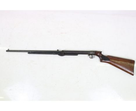 A vintage B.S.A. air rifle, BSA logo carved to the polished wooden, overall length approx 110cm. 