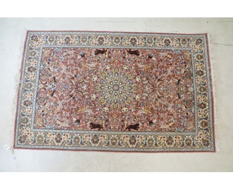 Persian style Rug, the pink ground with a pattern of stylised hunting big cats and deer with birds and flowers, 218cm x 139cm