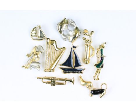 Collection of nine gilt metal brooches, to include enamelled examples, featuring golf clubs, fish, boats, harp, dog, etc. (La