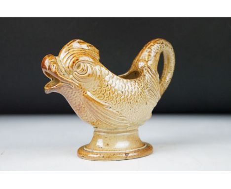 19th century salt glazed stoneware jug modelled as a mythological dolphin, probably Brampton, moulded with scales, the tail f