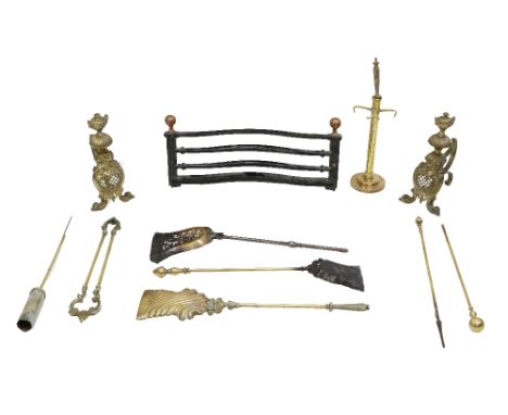 A pair of attractive rococo style Fire Dogs, each with urn finial, a serpentine shaped steel and brass mounted grate front, a