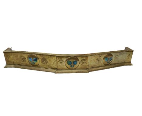 A very heavy Art Nouveau brass Fender, of breakfront outline, probably by Liberty &amp; Co., the frieze with ceramic inset op