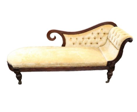 A late William IV mahogany Chaise Longue, with shaped button back and scroll end, carved rosette, covered in gold fabric on h