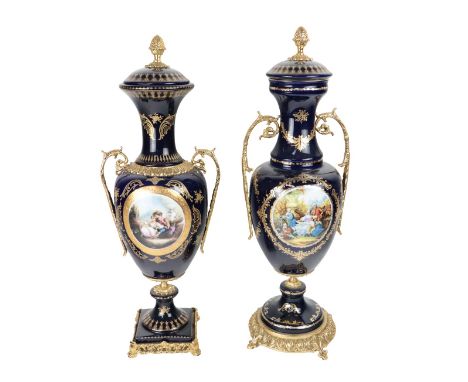 Two similar Serves style two handled porcelain and brass mounted Vases &amp; Covers,&nbsp;each dark blue ground with print pa