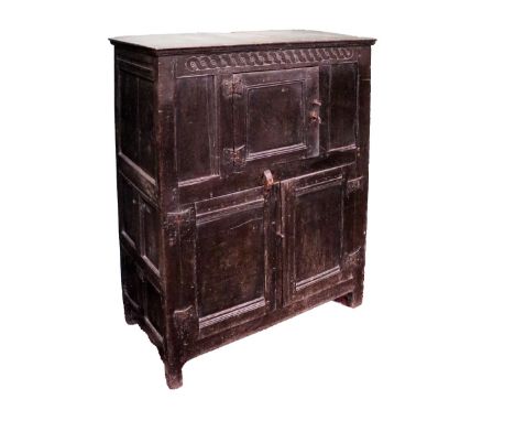A carved oak Buffet or Food Cupboard, 18th Century and later, the moulded top above a ribbon moulded interlaced frieze above 
