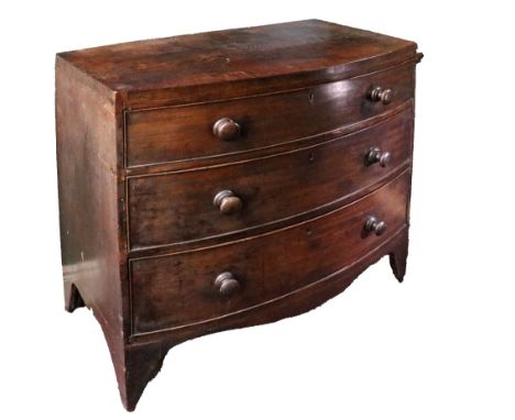 A Georgian mahogany bow fronted Chest, of small proportions with ebony inlay over three long drawers and turned handles on br