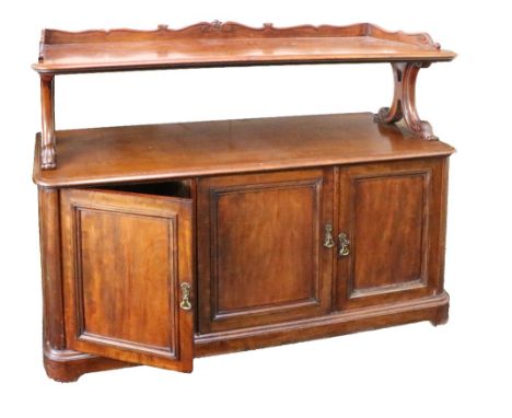 A Victorian mahogany Buffet, with carved and shaped gallery back above shaped supports and open shelf, on a base with three p