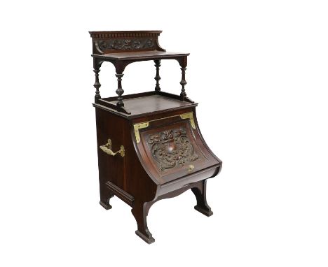 An Edwardian&nbsp;walnut Purdonium, with dentil moulded cornice with shelf on turned supports, above a curved and carved comp