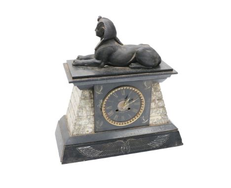 An Egyptian Revival black slate and variegated&nbsp;marble Mantle Clock, (lacking movement), the top surmounted with a reclin
