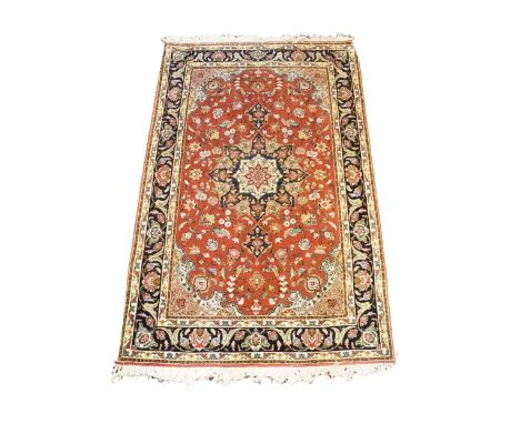 An attractive Oriental Rug, the claret center with attractive floral bouquets inside a narrow navy ground, with conforming bo