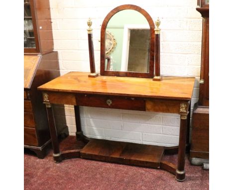 A good Empire mahogany and brass mounted Dressing Table, the arched swing frame mirror supported by two pillars, each with a 