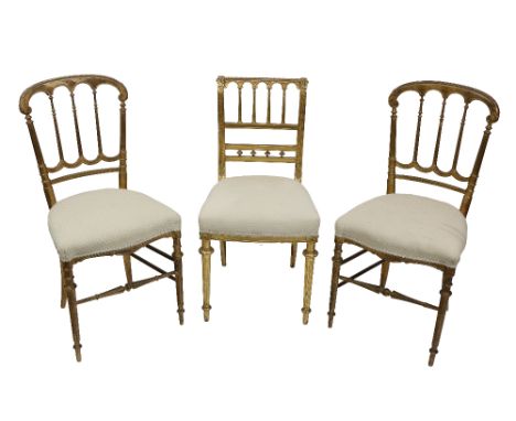 A pair of late 19th Century gilt Banquet Chairs, each with a four arch back with turned rails, together with another similar 