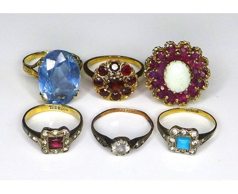 A group of six 9ct gold and silver rings, comprising a 9ct gold dress ring in the form of a flowerhead, the central opal of 1