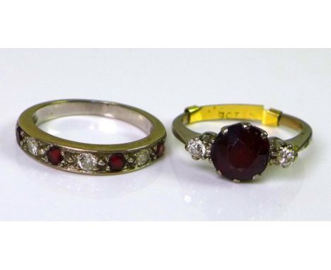 A 9ct white gold ring set with central large garnet flanked by two diamonds, approx 0.15cts total diamond weight, size P, 4.6