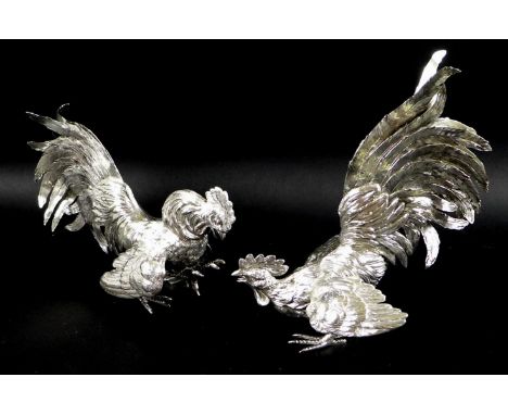 A pair of silver fighting cockerels, each cast with feathered detailing, London import mark, 1957, J R &amp; Co Ltd, 23 by 13