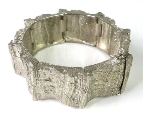 A Danish silver cuff bangle formed of eight connected panels with bark texturing, marked Anton Michelsen 925S, KA, 86g. 