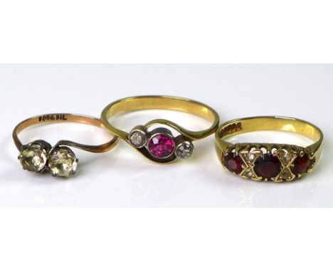 A group of three rings, one a late 19th or early 20th century three stone ring, central pink stone, possibly a ruby, flanked 