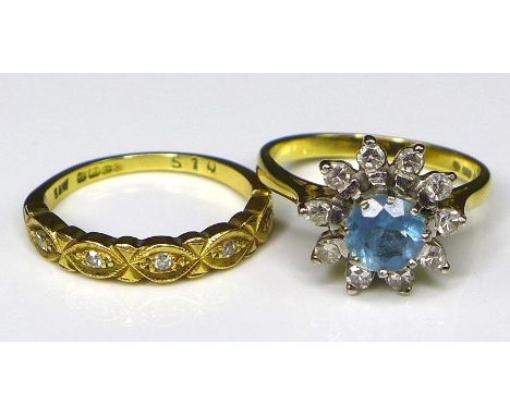 An 18ct gold, diamond and aquamarine ring, the central round cut aquamarine of 6mm diameter and surrounded by 10 diamonds in 