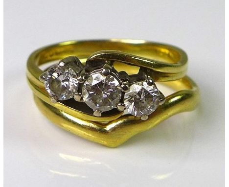 An 18ct gold three stone diamond ring, the central diamond of approx 0.25cts flanked by two diamonds of approx 0.2cts, approx