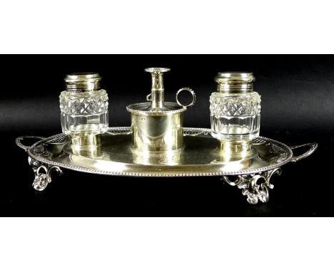 A George III and Victorian silver desk stand of oval twin handled form, with swag decoration within a pierced and beaded rim,