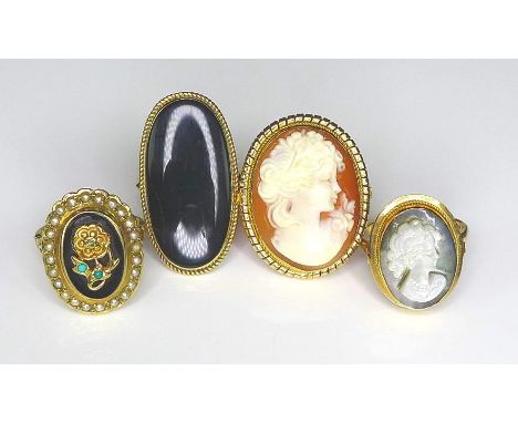 A group of 9ct gold rings of Victorian design, comprising two cameo rings, one set against a carnelian background, the other 