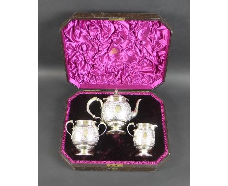 A Victorian silver bachelor's three piece tea service, comprising teapot, milk jug and sucrier, the bodies chased and embosse