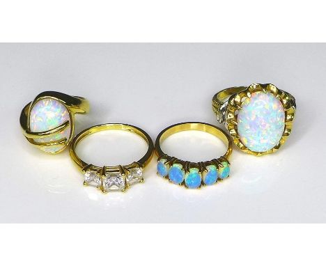 A group of three 15ct gold rings, comprising a ring set with a large oval opal in a scalloped claw setting, rope twist and le