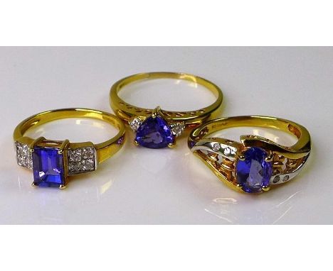 A group of three 18ct gold dress rings, each set with diamonds and tanzanites, two size N, one size R, 9.6g total. (3) 