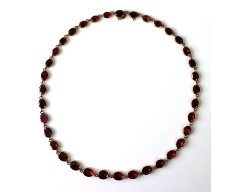 An 18th/19th century rose gold and red stone necklace, the stones possibly garnets, oval cut and in rub over settings, unmark