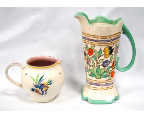 Bursley Ware Charlotte Rhead water jug, 23cm high, and a Poole Pottery milk jug, 11cm high.  (2)