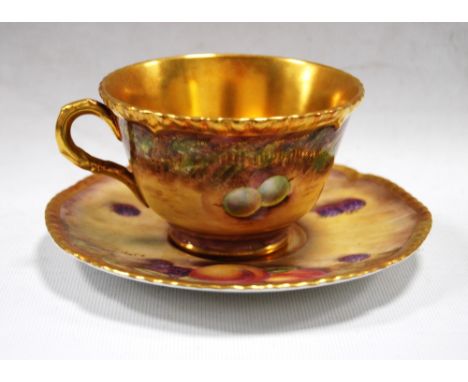 Royal Worcester gilt porcelain tea cup and saucer decorated with fruit, signed S. Drysdale, 7cm high.   Condition Report  The